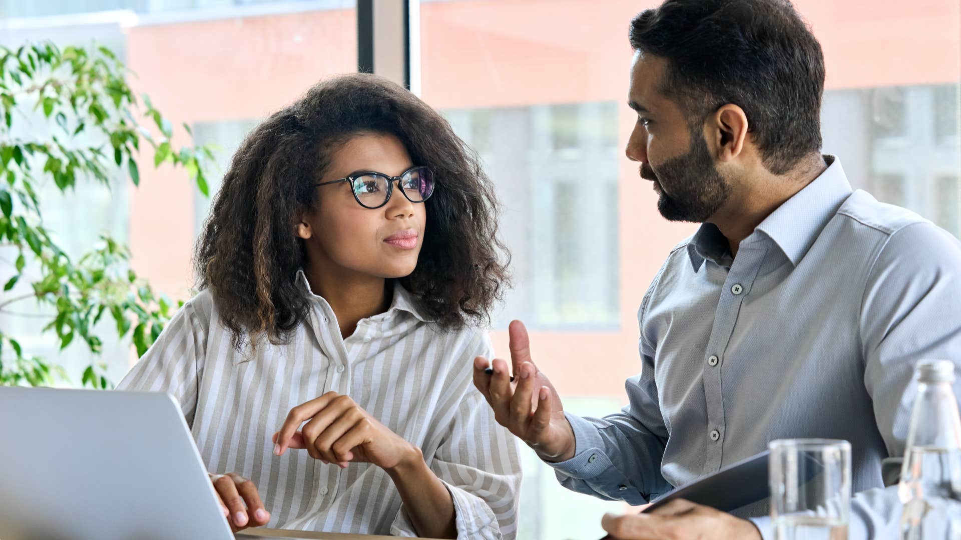 professional man telling colleague to read between the lines