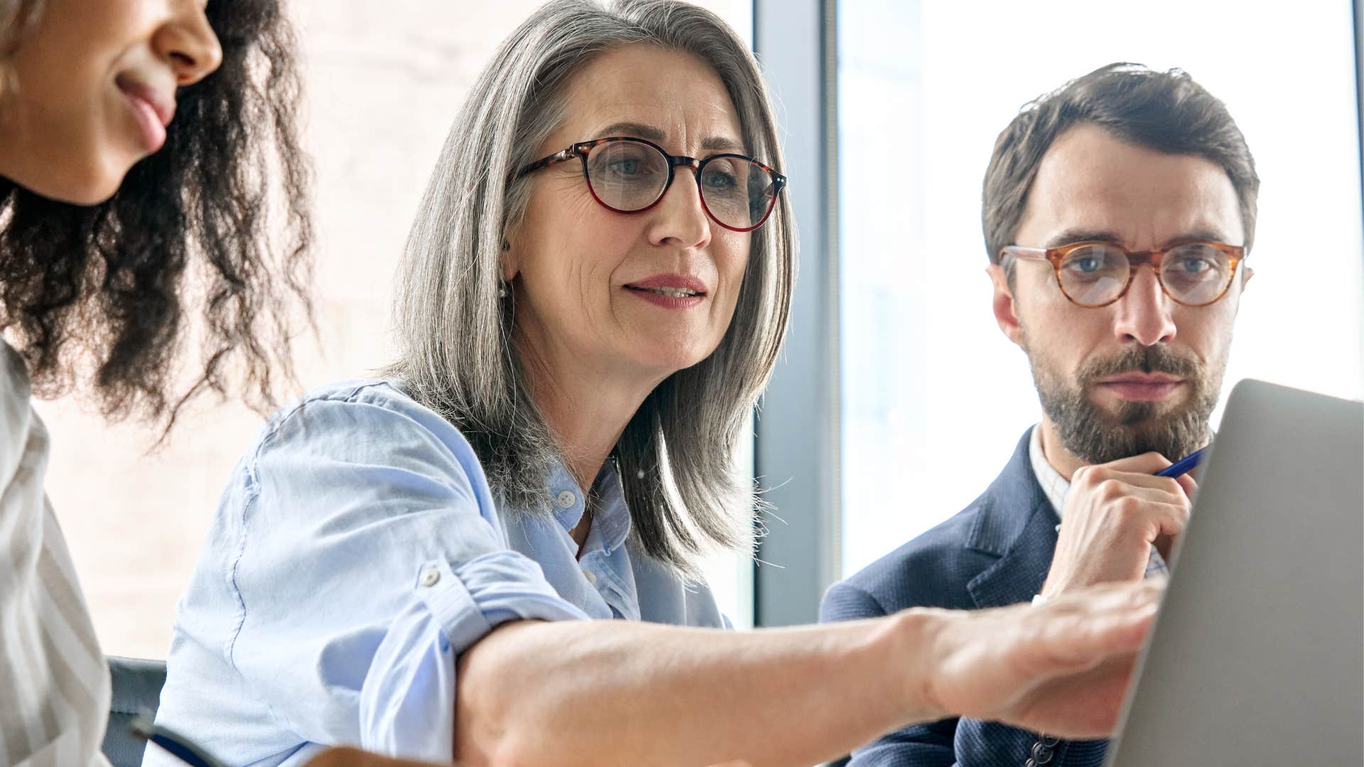 An elderly woman tells her co-workers that the job keeps moving the goalposts.