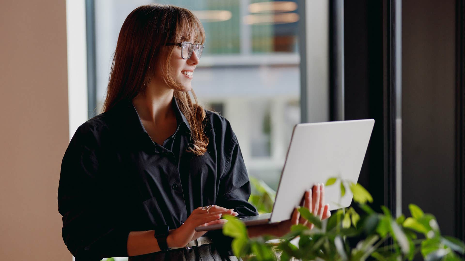 A woman thinks long-term while using her computer.
