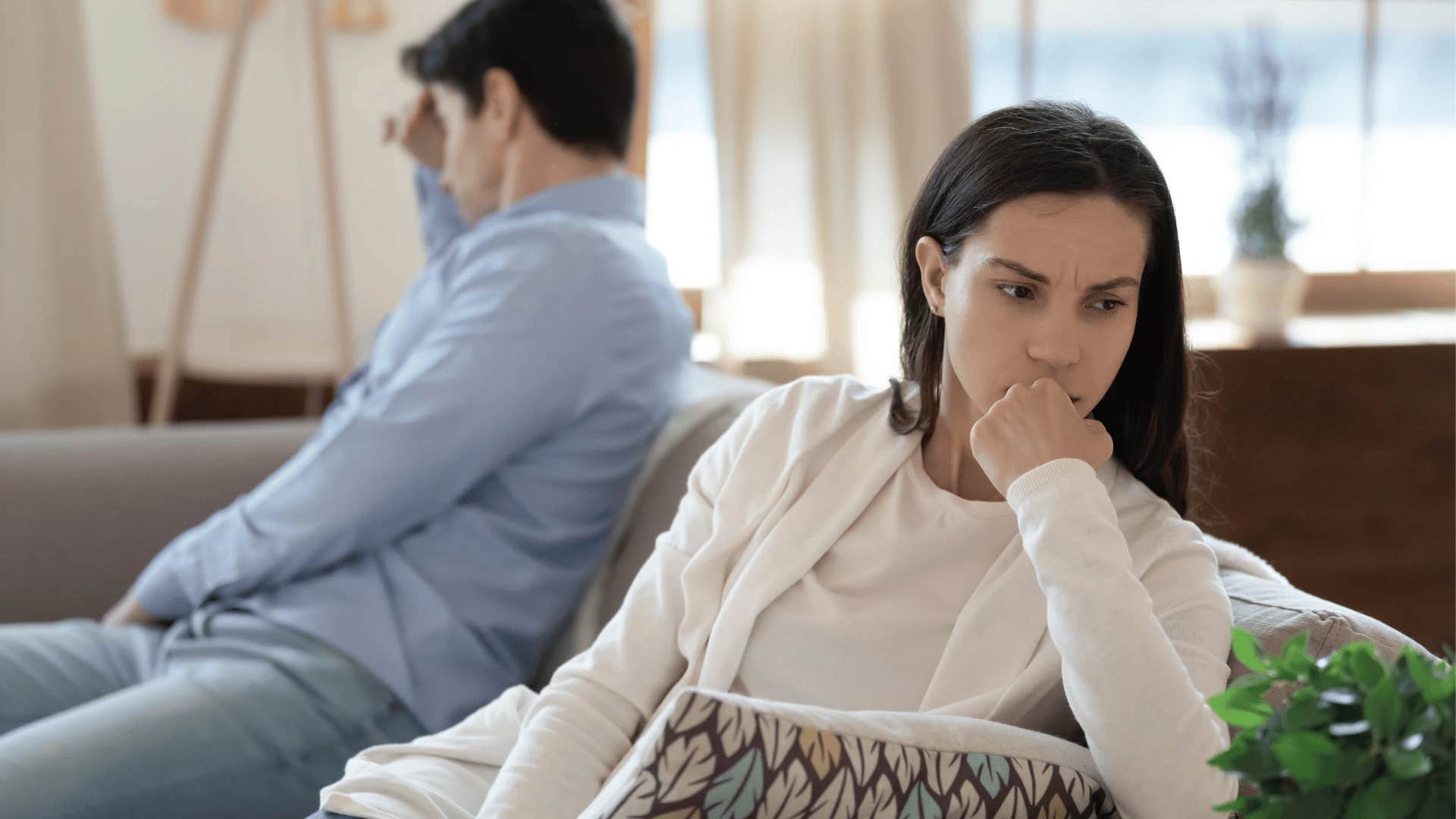 pensive woman turned away from man
