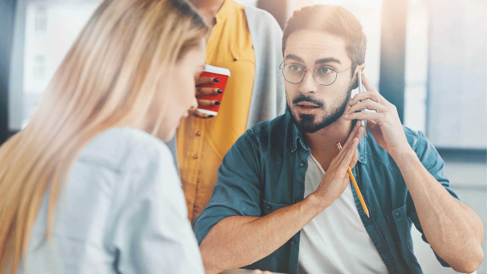 man on phone trying to end a conversation with a colleague