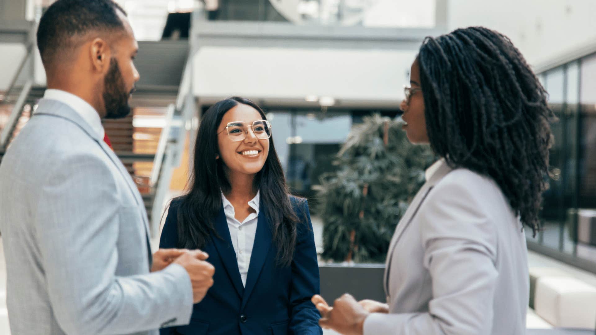 happy colleagues talking about work