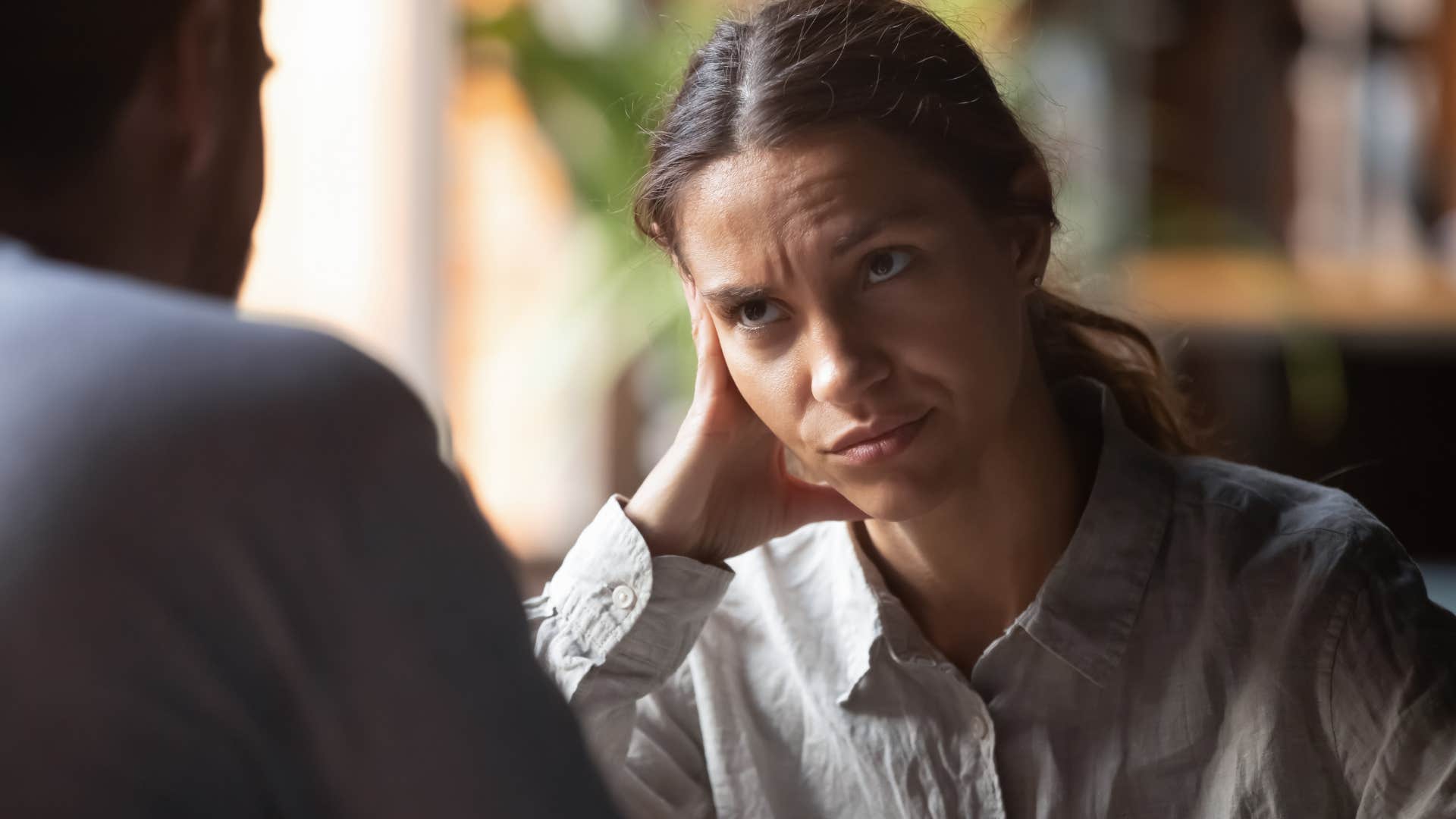 Annoyed woman looking at a man who said "no offense, but..."