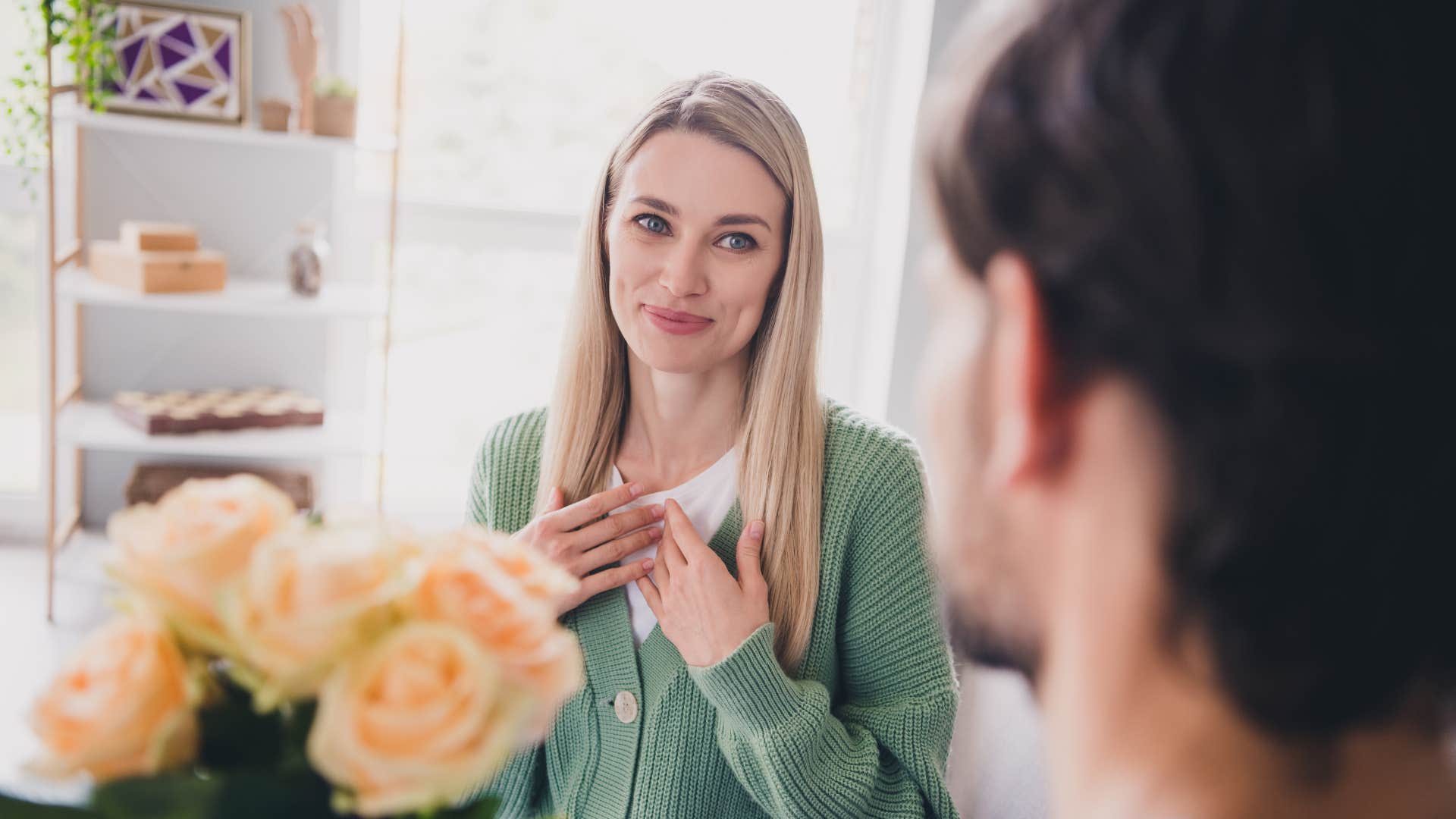 A man gives his wife flowers, appreciating everything she does for him.