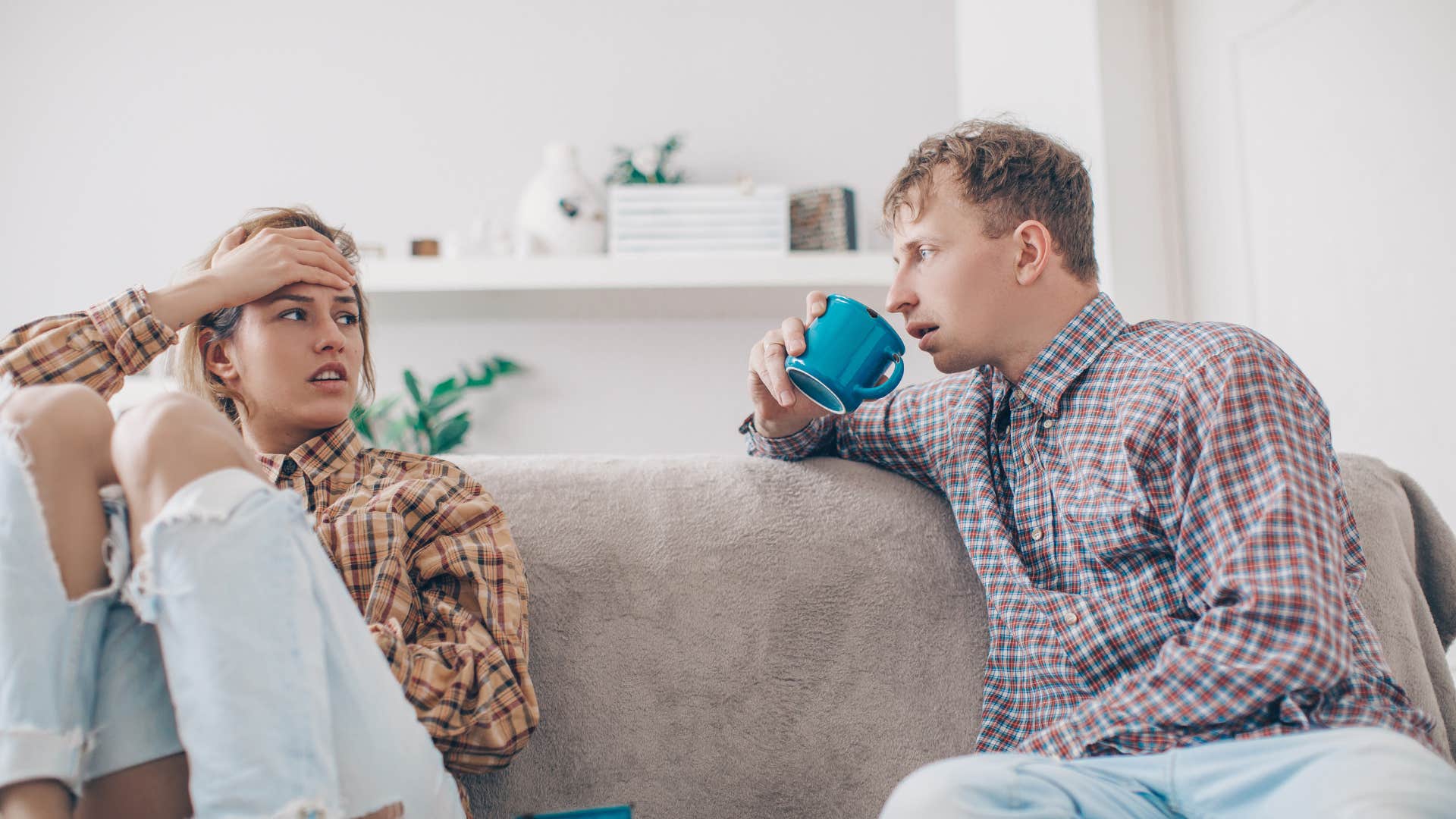 couple sitting on couch having conversation