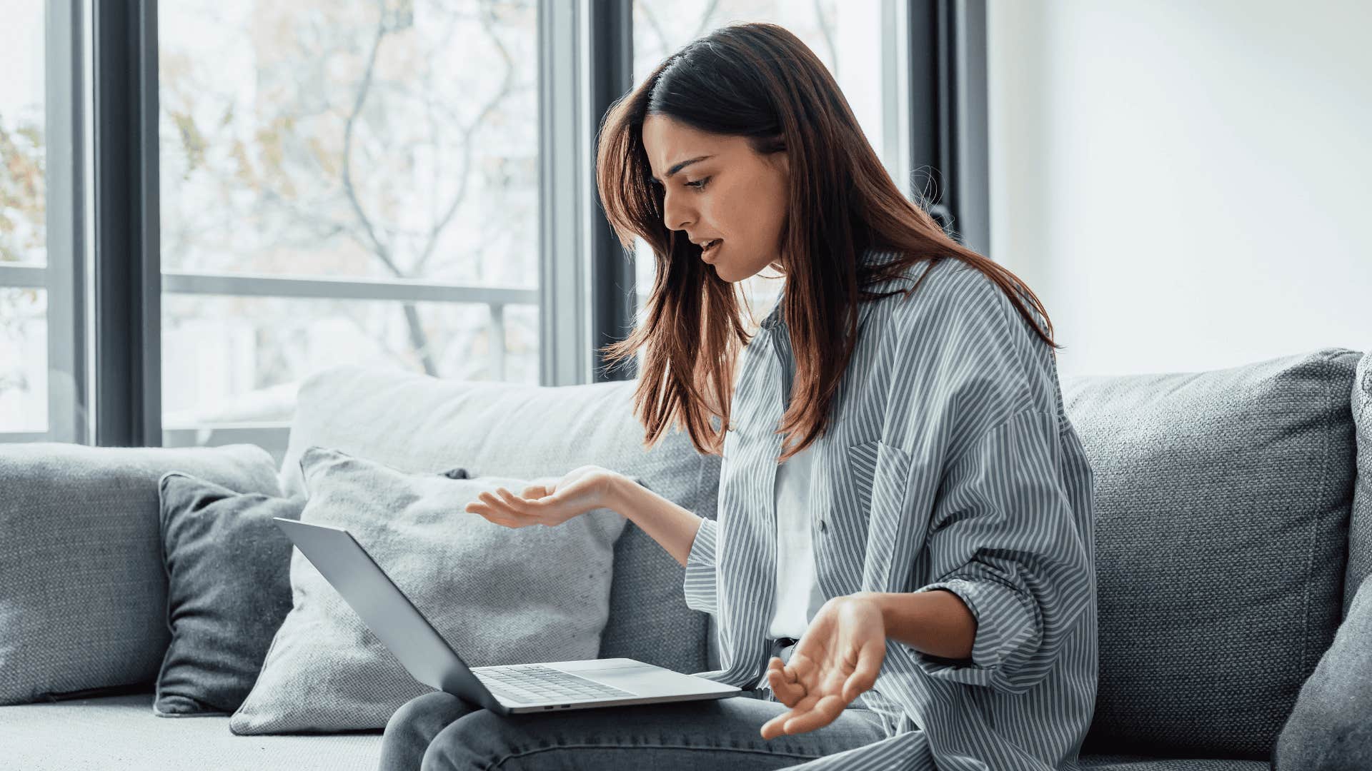 upset woman with laptop who prefers predictable pain