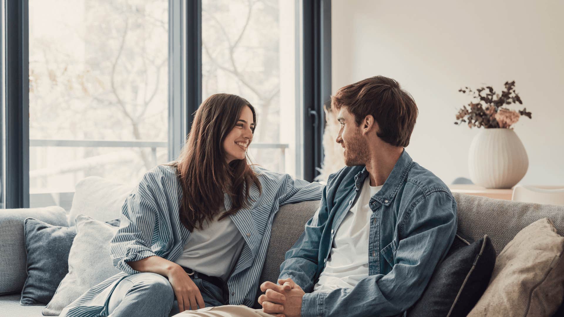 man who is a darn good husband talking to smiling wife