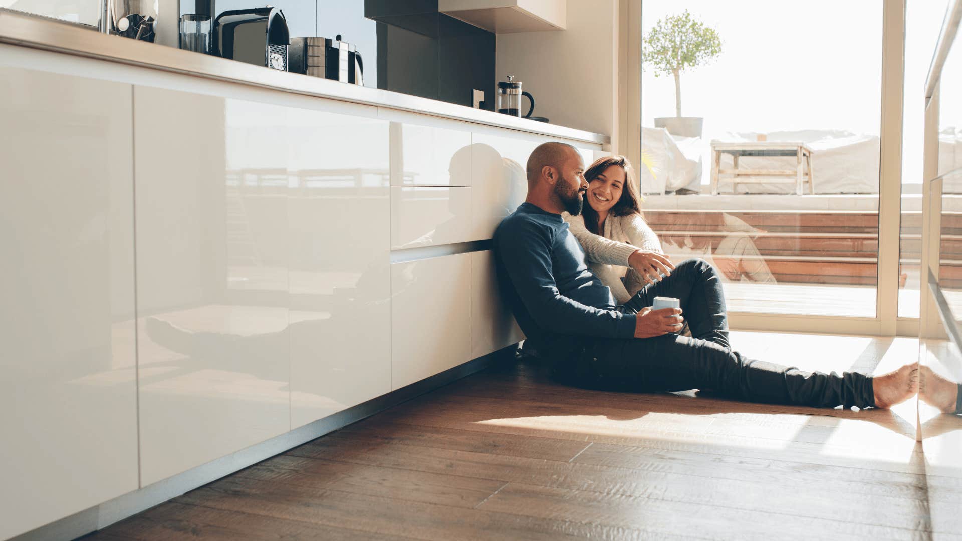 man who is a darn good husband sitting next to wife on floor