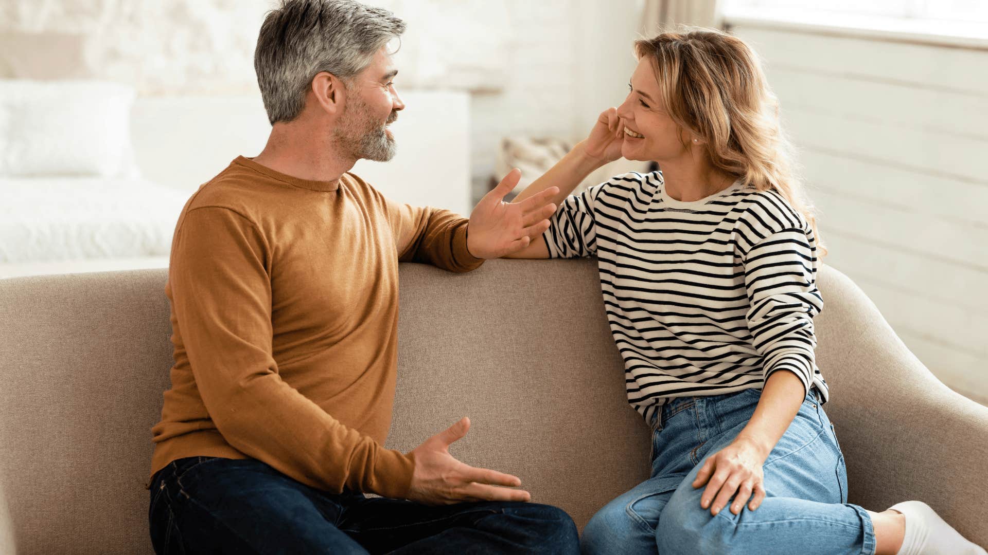 smiling man who is a darn good husband sitting next to wife