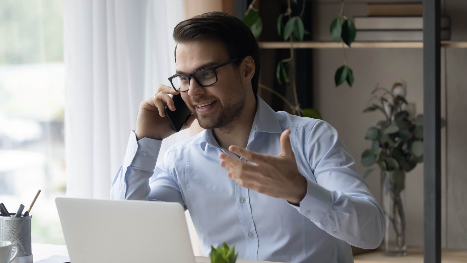 man in blue shirt asking person on the phone what's one thing you're terrible at
