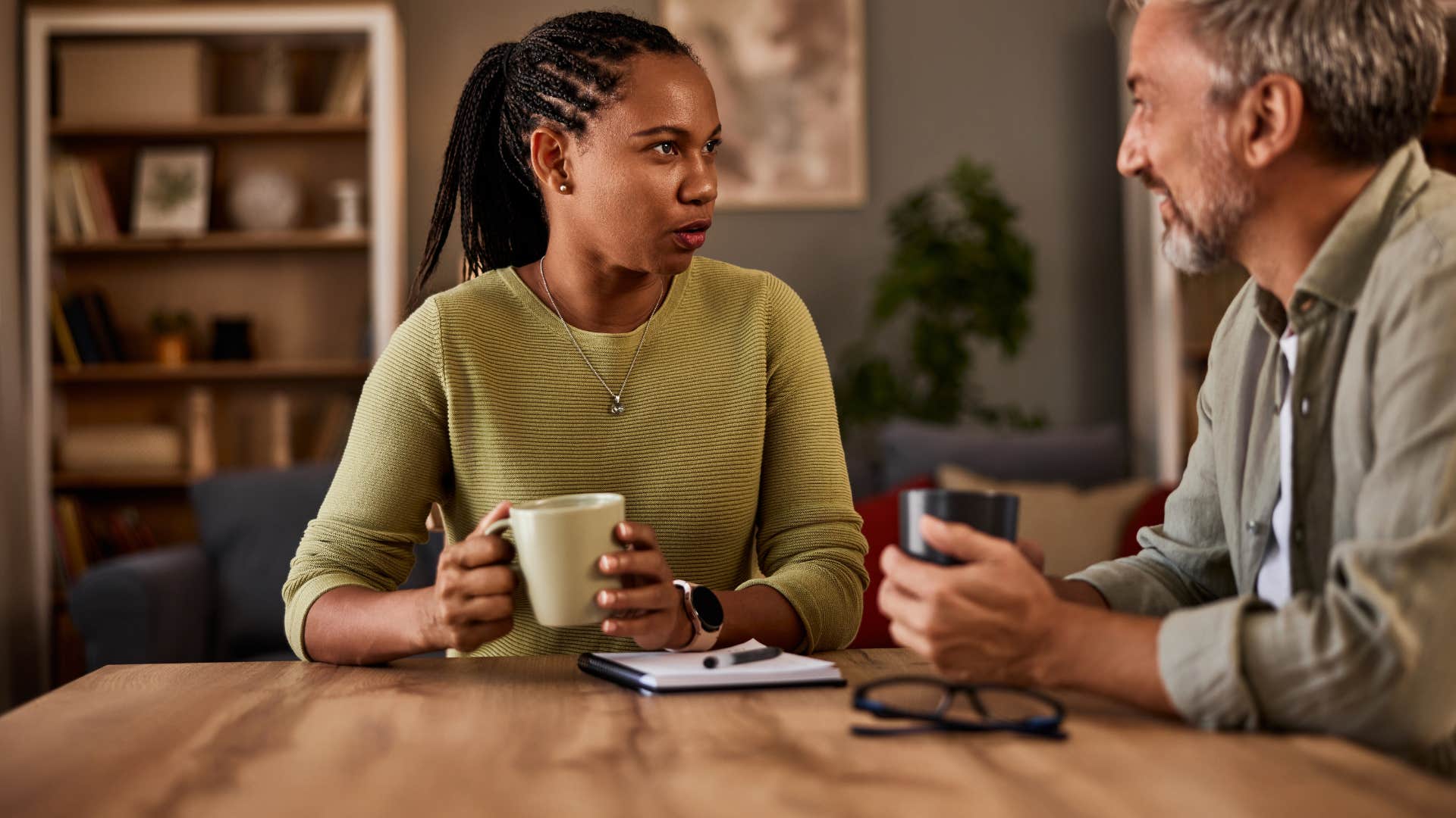 woman asking man what's one thing people misunderstand about you when meeting you for the first time as she drinks coffee and sits across from him