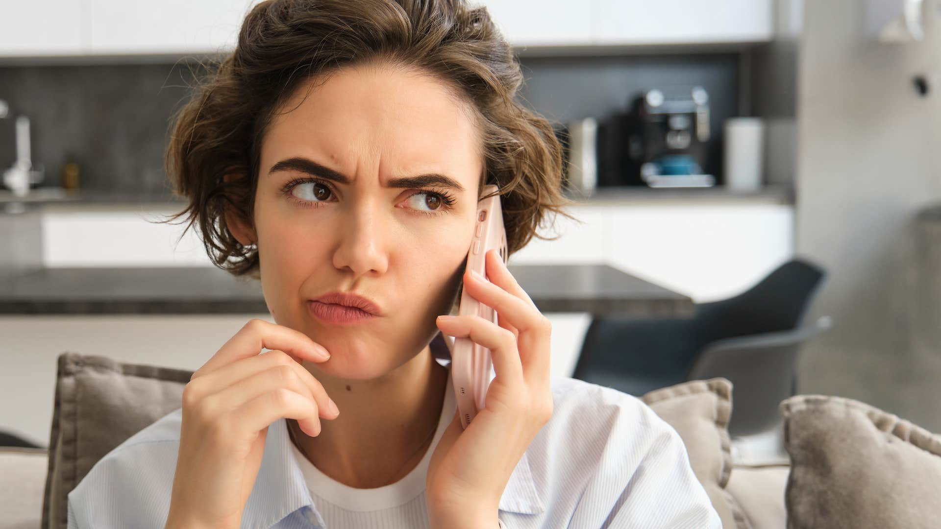 woman thinking as person on the phone asks her what's one value she'll never compromise on