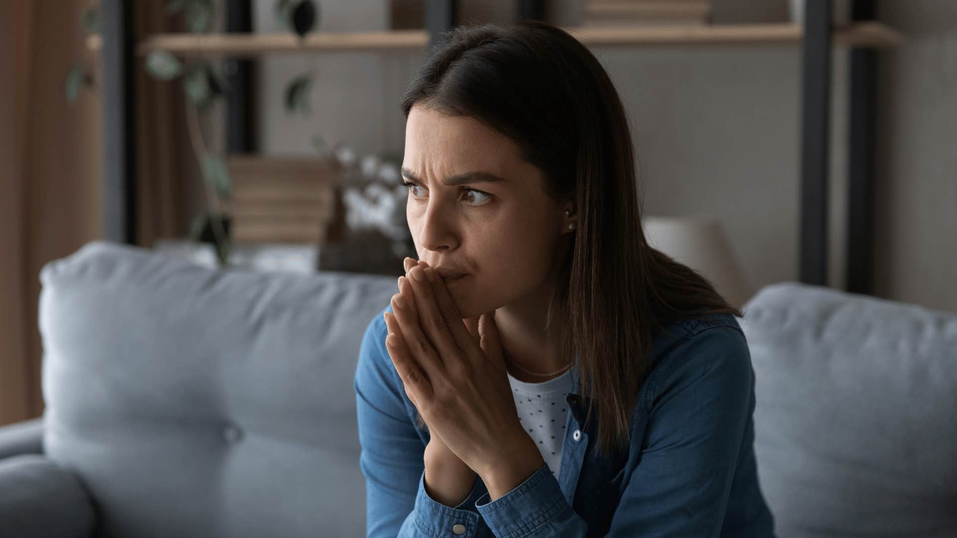 woman filled with guilt as she puts her head in her hands 