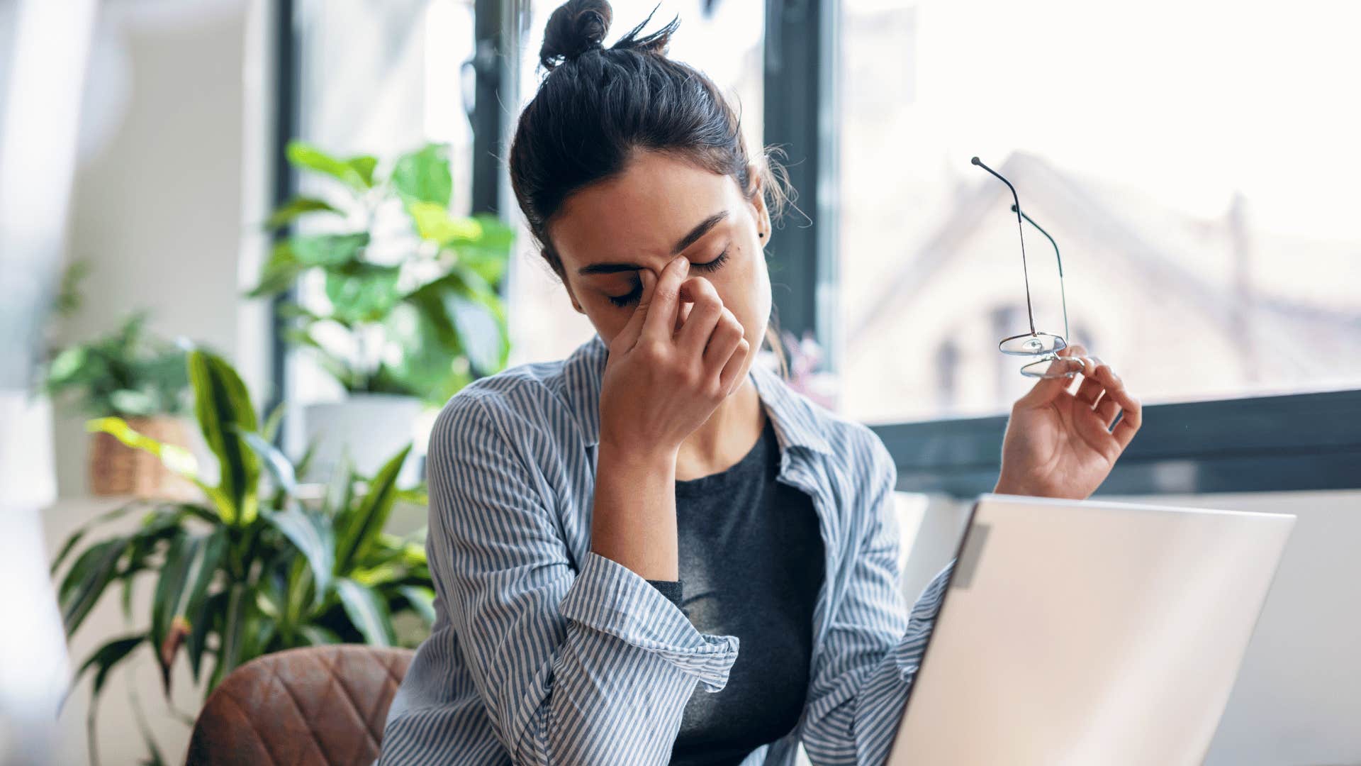 woman looking exhausted as her exhaustion takes a toll on her mental health 