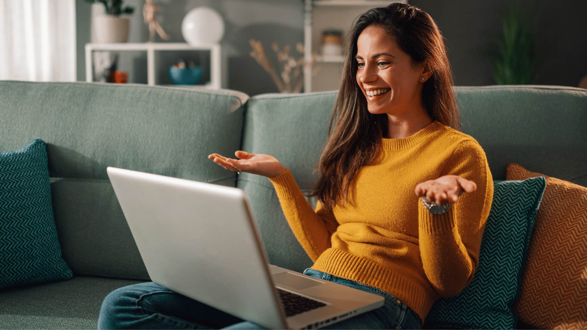 woman preferring to work as she hops onto a conference call on her laptop while smiling