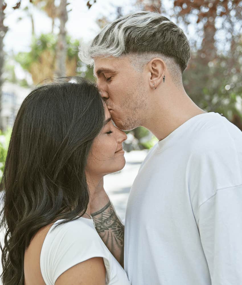 Memorable man kisses woman in park to show his feelings