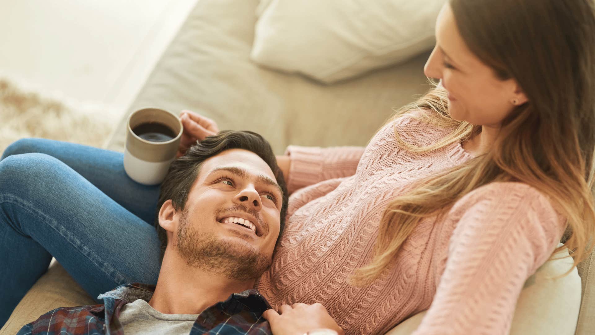 man who is unforgettable with his head in his wife's lap