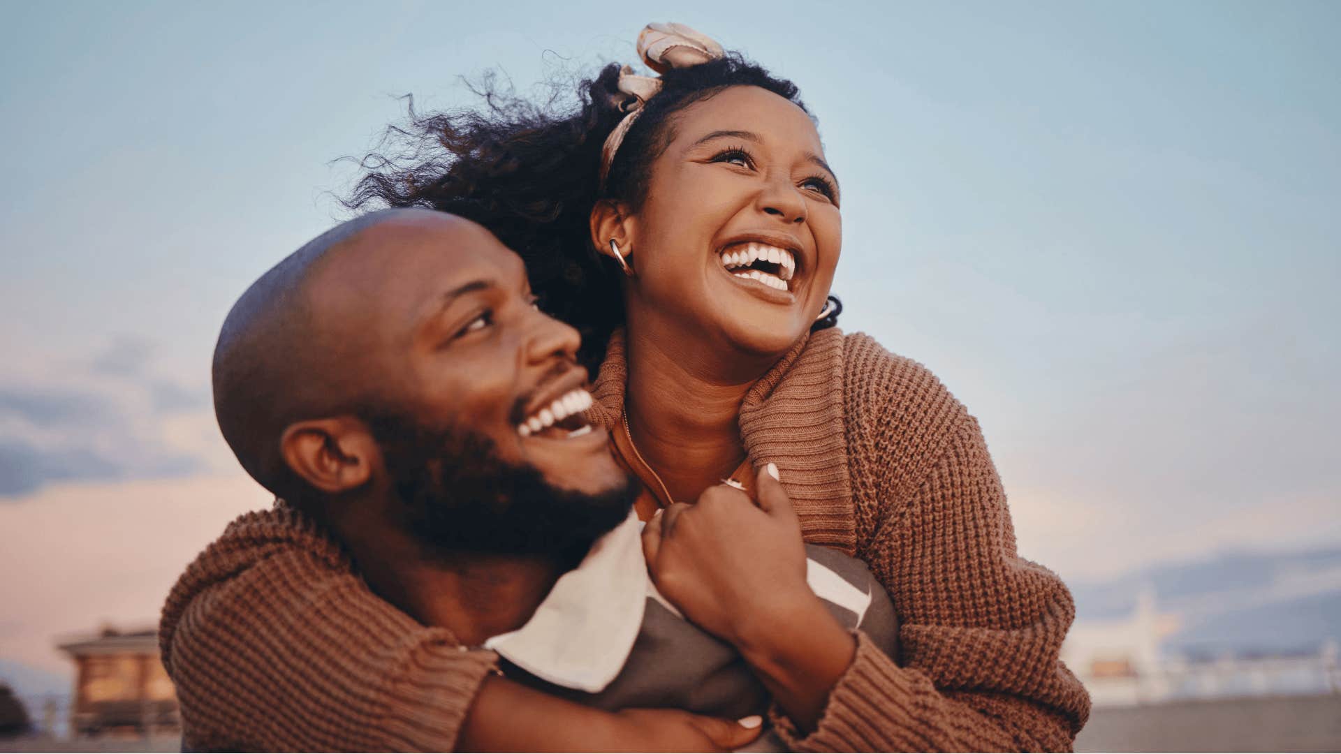 smiling impressive man with woman on his back