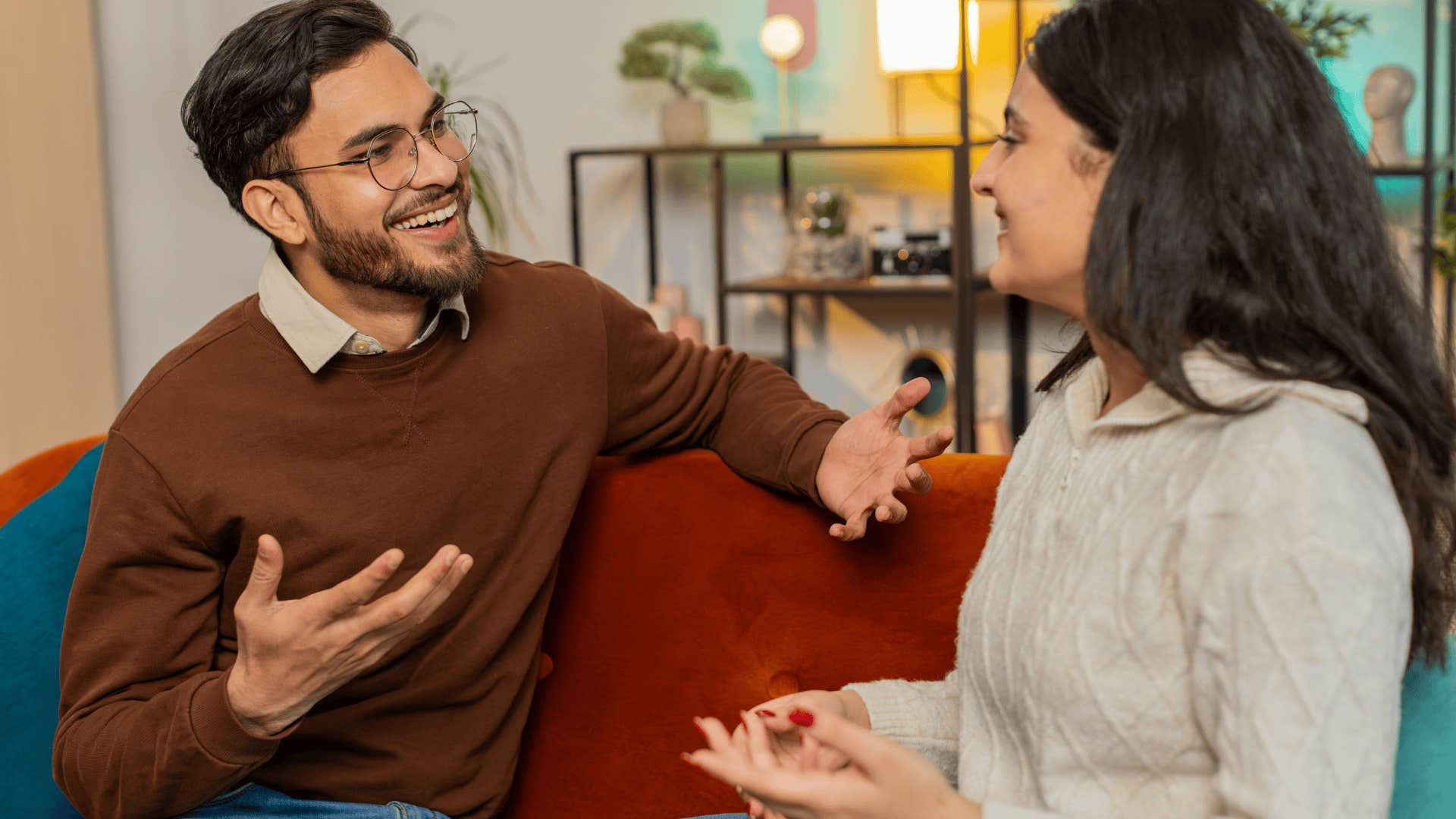 impressive man smiling and talking to a woman