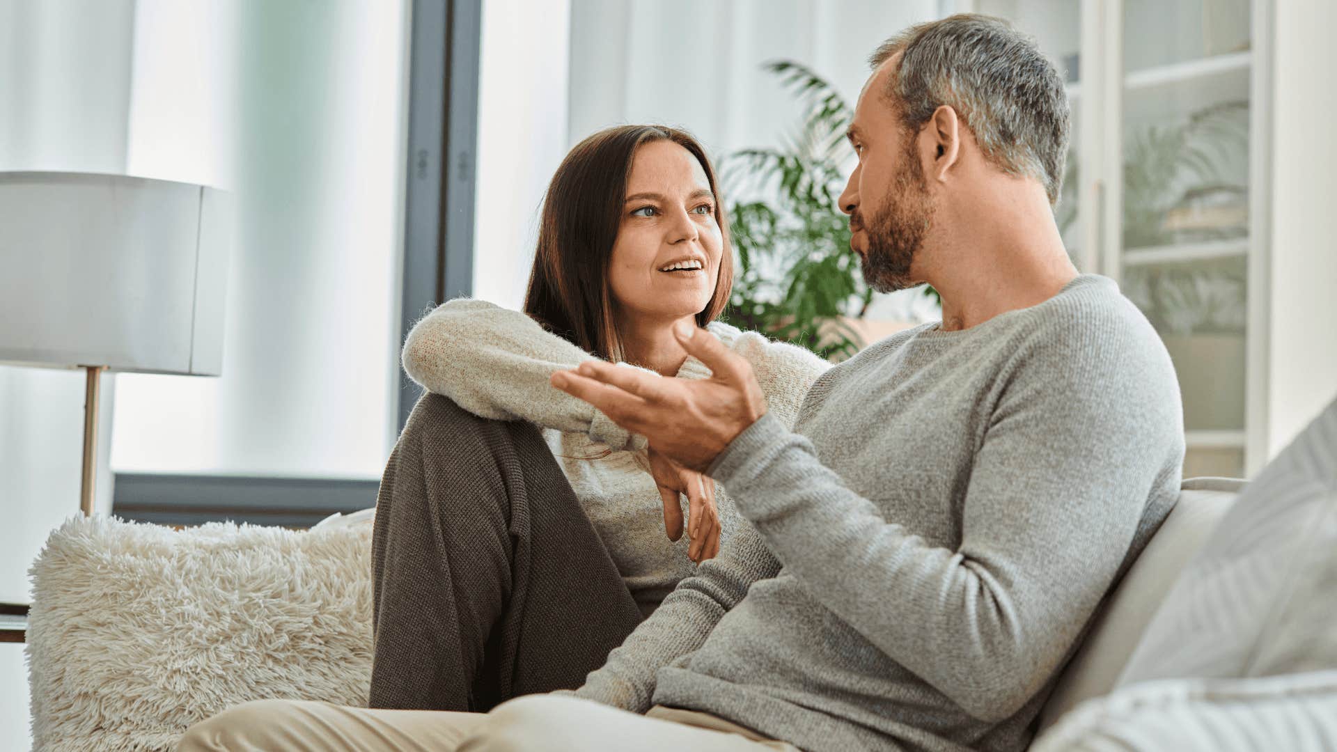 smiling woman talking to impressive man