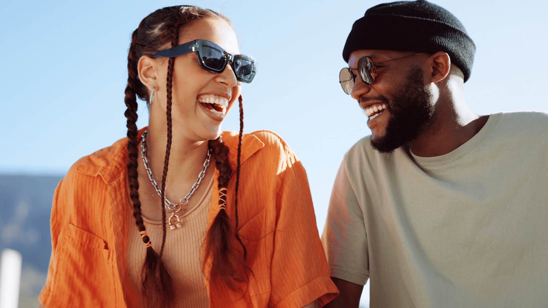 smiling woman sitting next to unforgettable smiling man