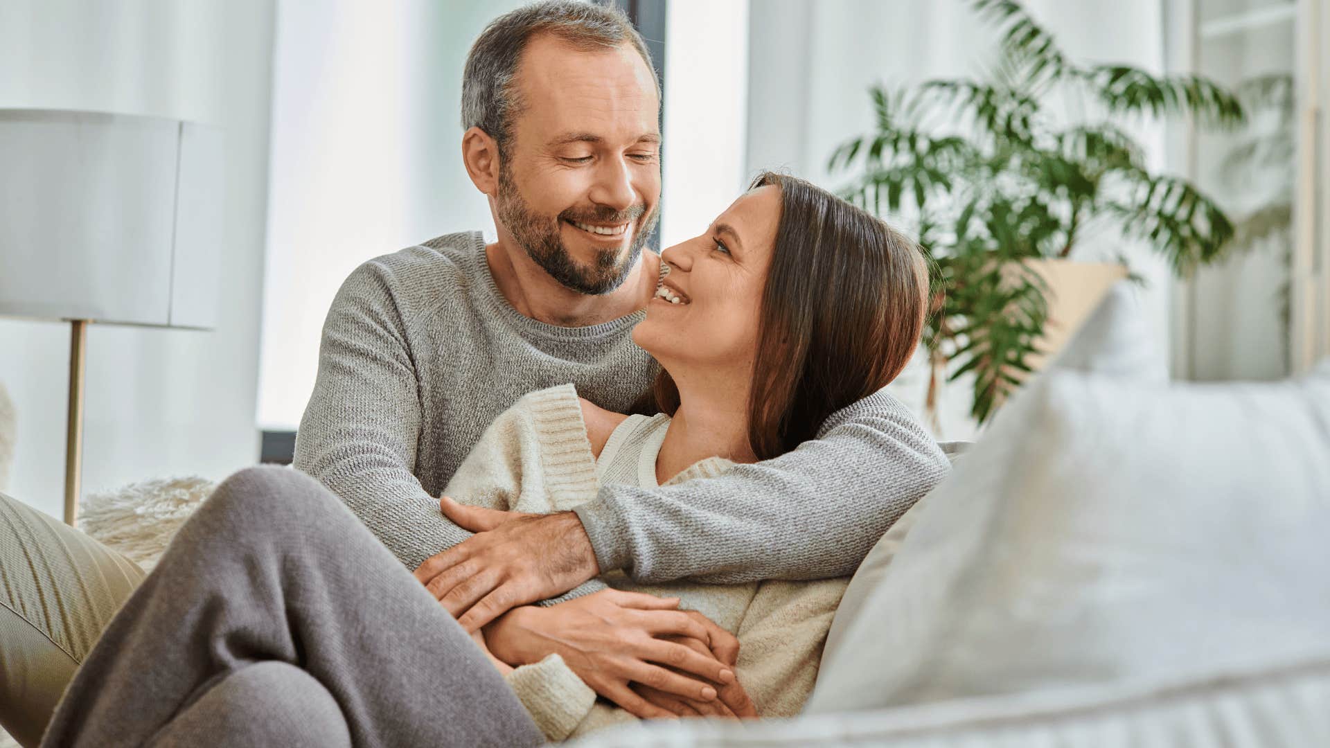 smiling man holding impressive woman