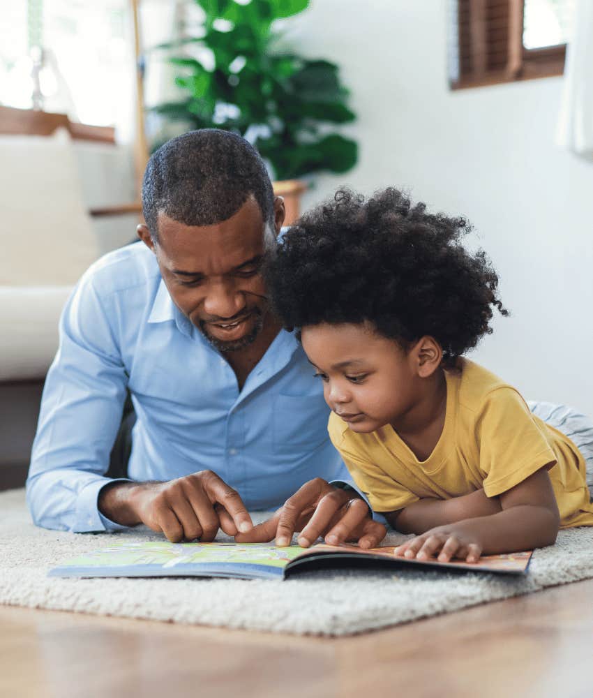 Memorable dad interacts with child an book on their level