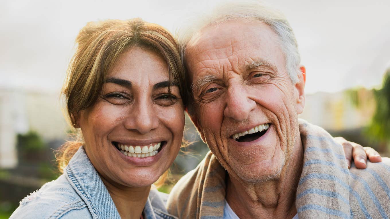 Rare Signs You Were Raised By A High-Quality Parent, According To Psychology happy woman smiling next to high-quality parent