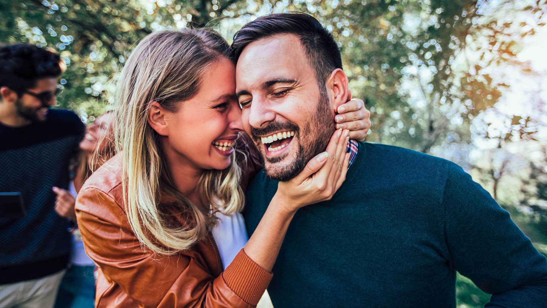 couple laughing and hugging over hilarious inside jokes