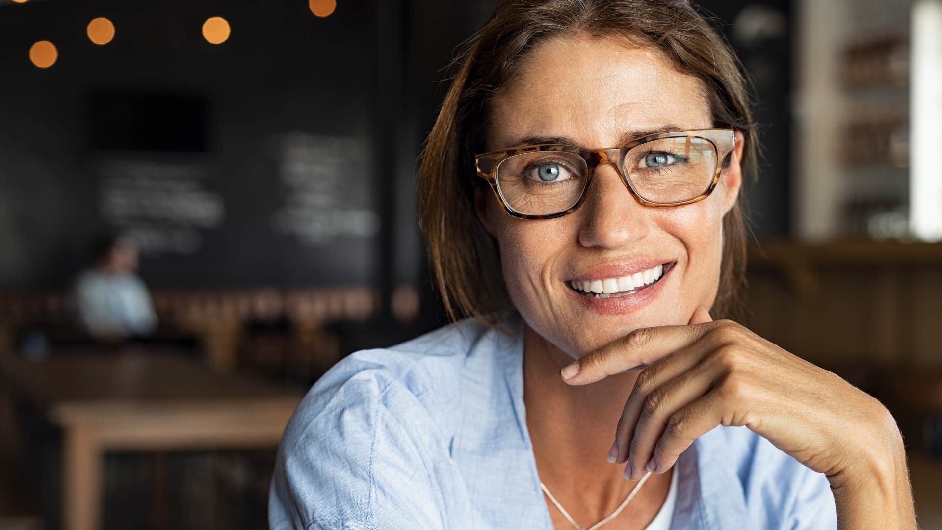 low-key woman smiling