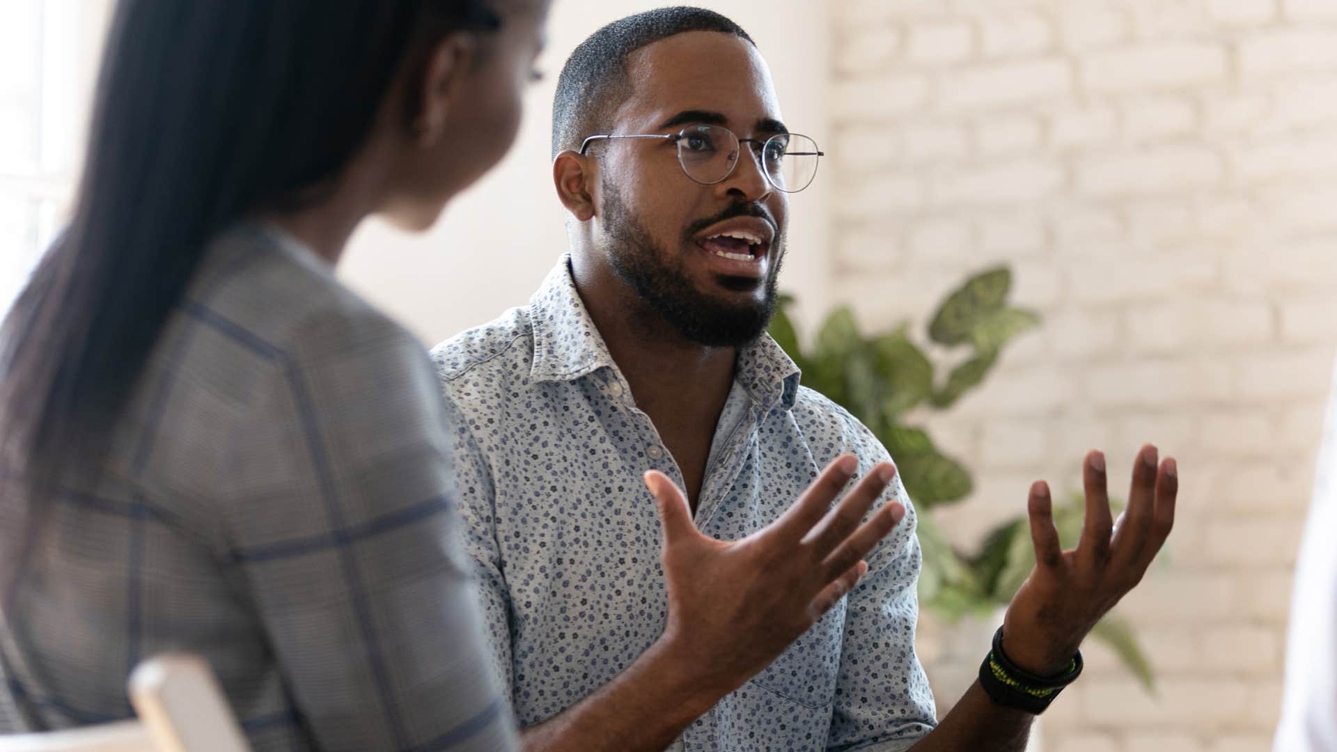 man ignoring people in a conversation