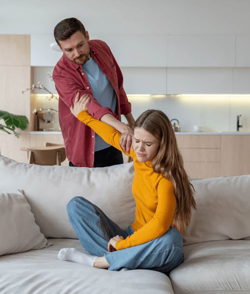 Arguing couple holds on while trying to let go