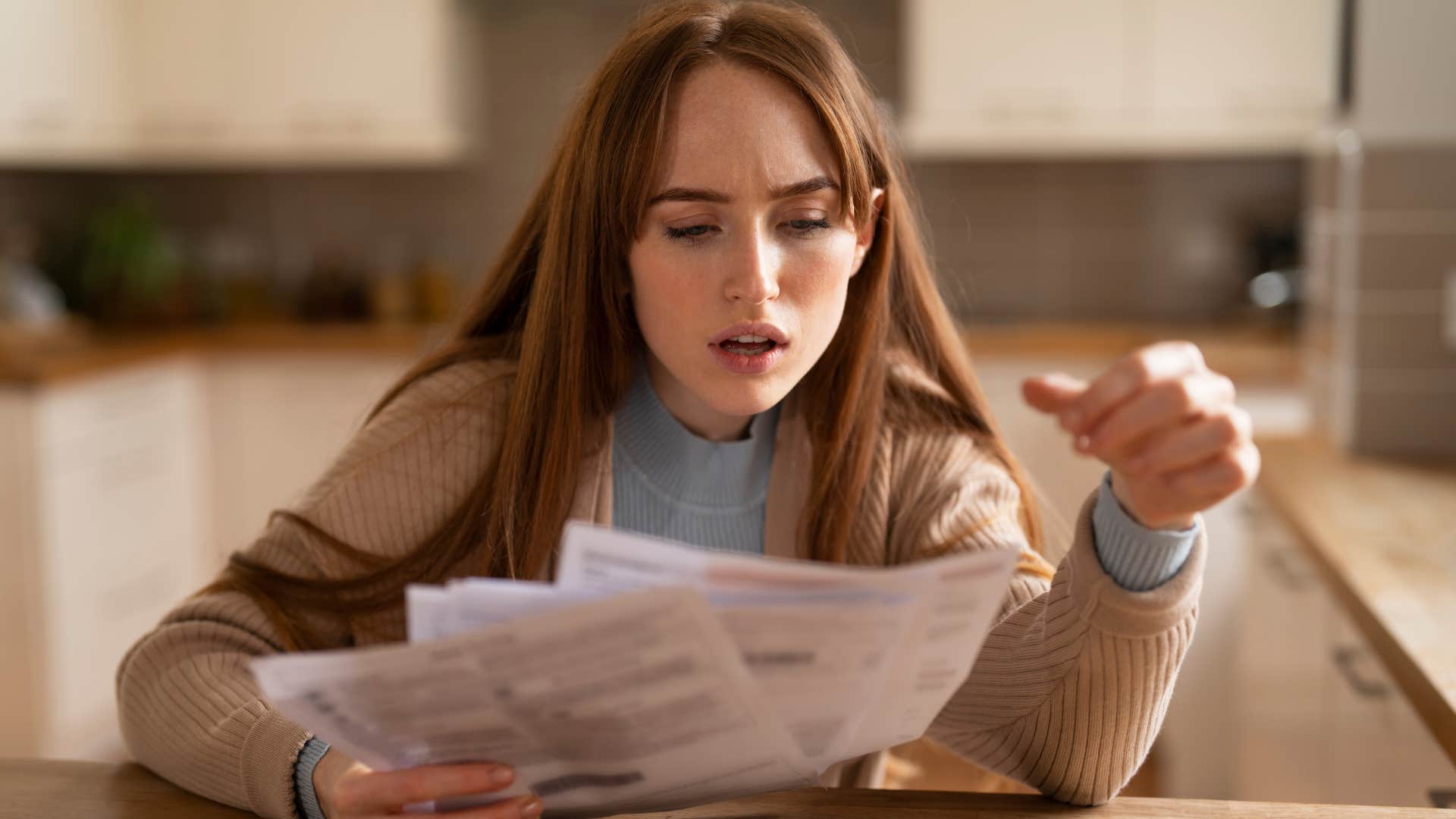 stressed gen z woman looking at bills unable to afford to pay