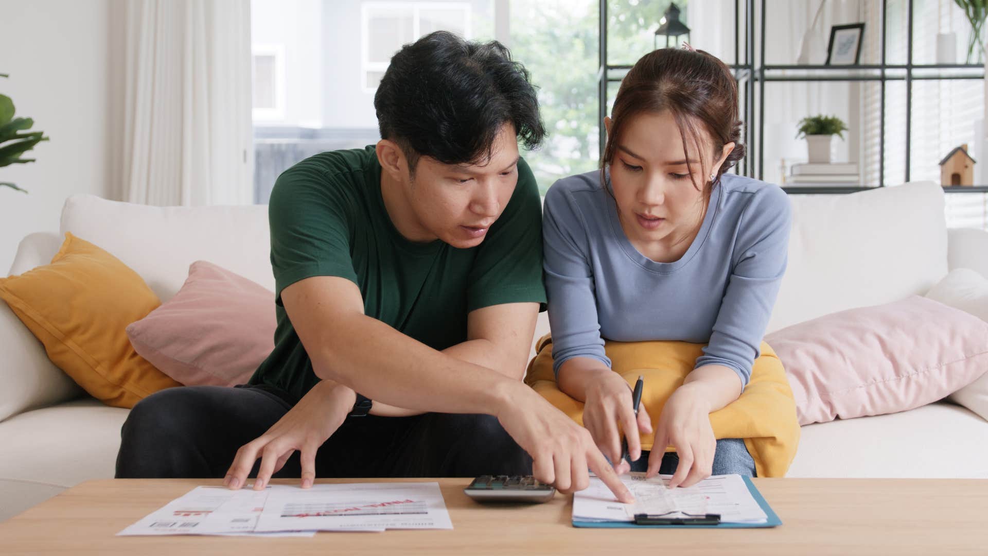 stressed young couple doing bills