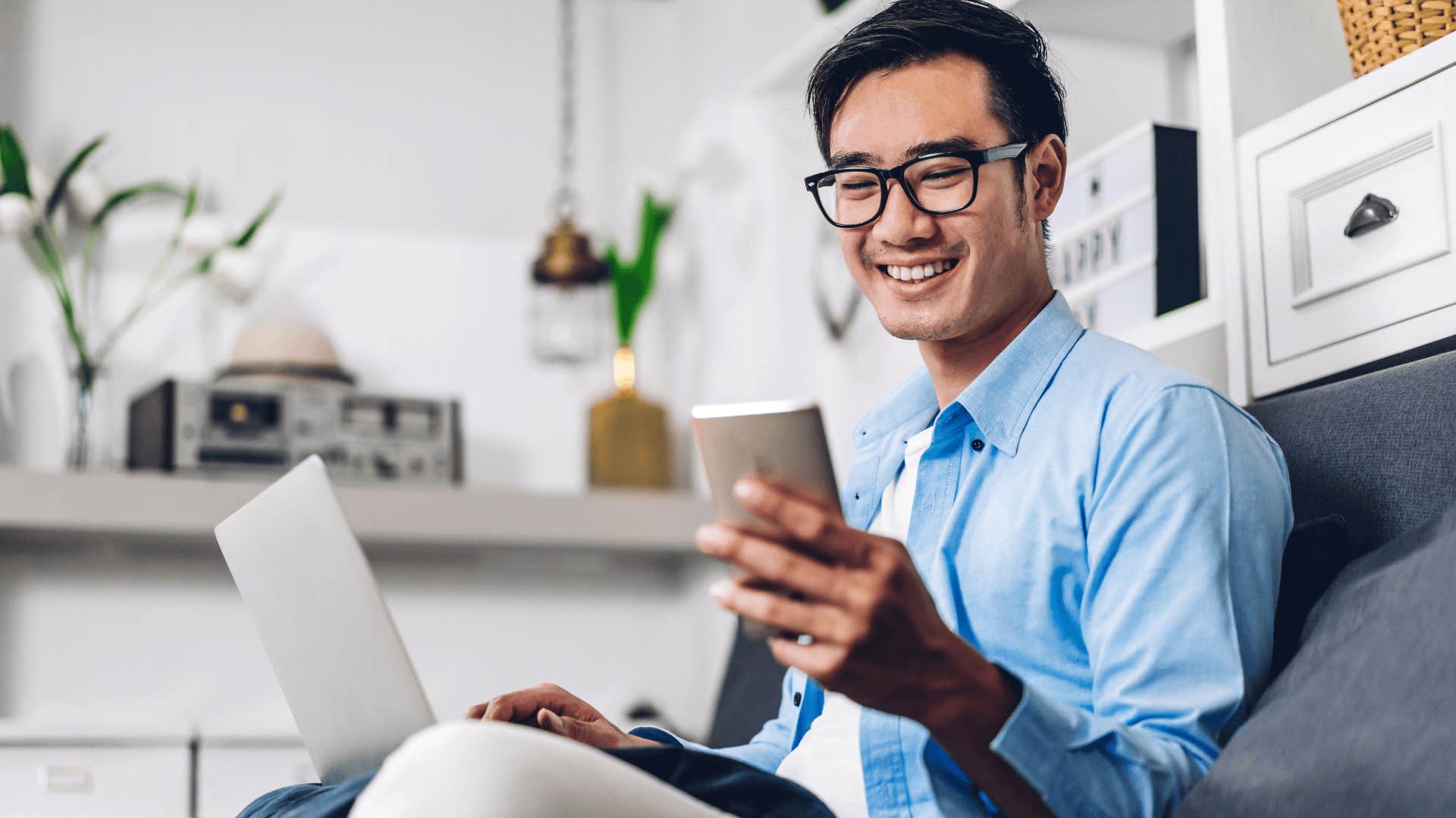 Young man embraces quiet solitude when looking at the group chat on his phone