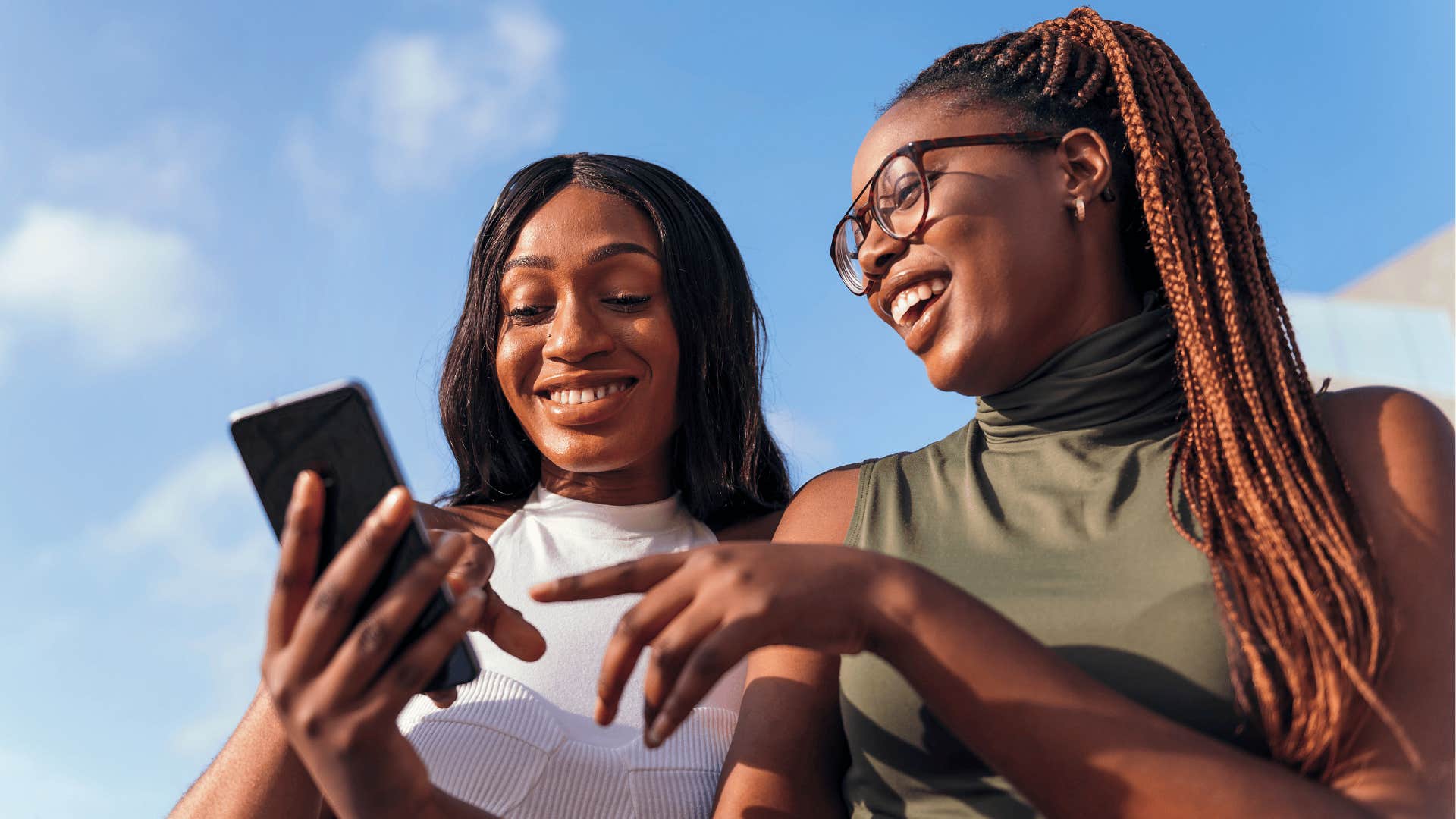 Two women communicate with purpose when texting in the group chat on their phone