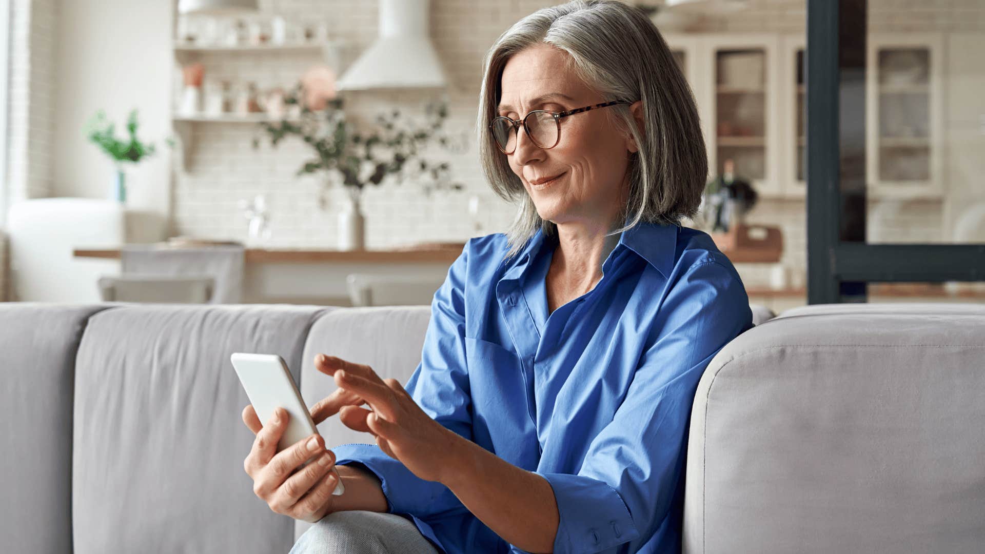 Woman reflects before responding to a text on her phone