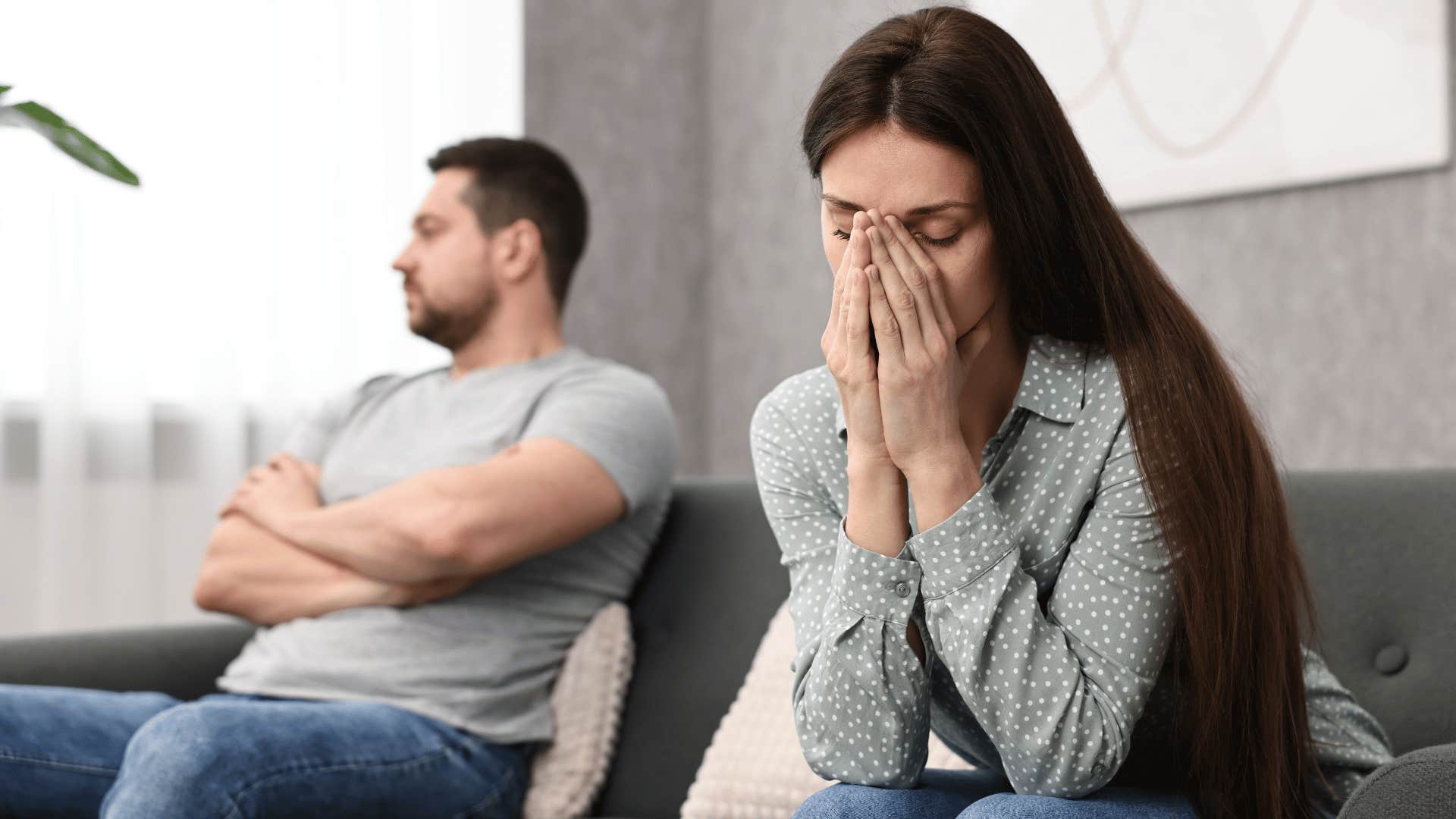 woman in gray shirt looking done with head in hands as she realizes her relationship is based on potential not reality 