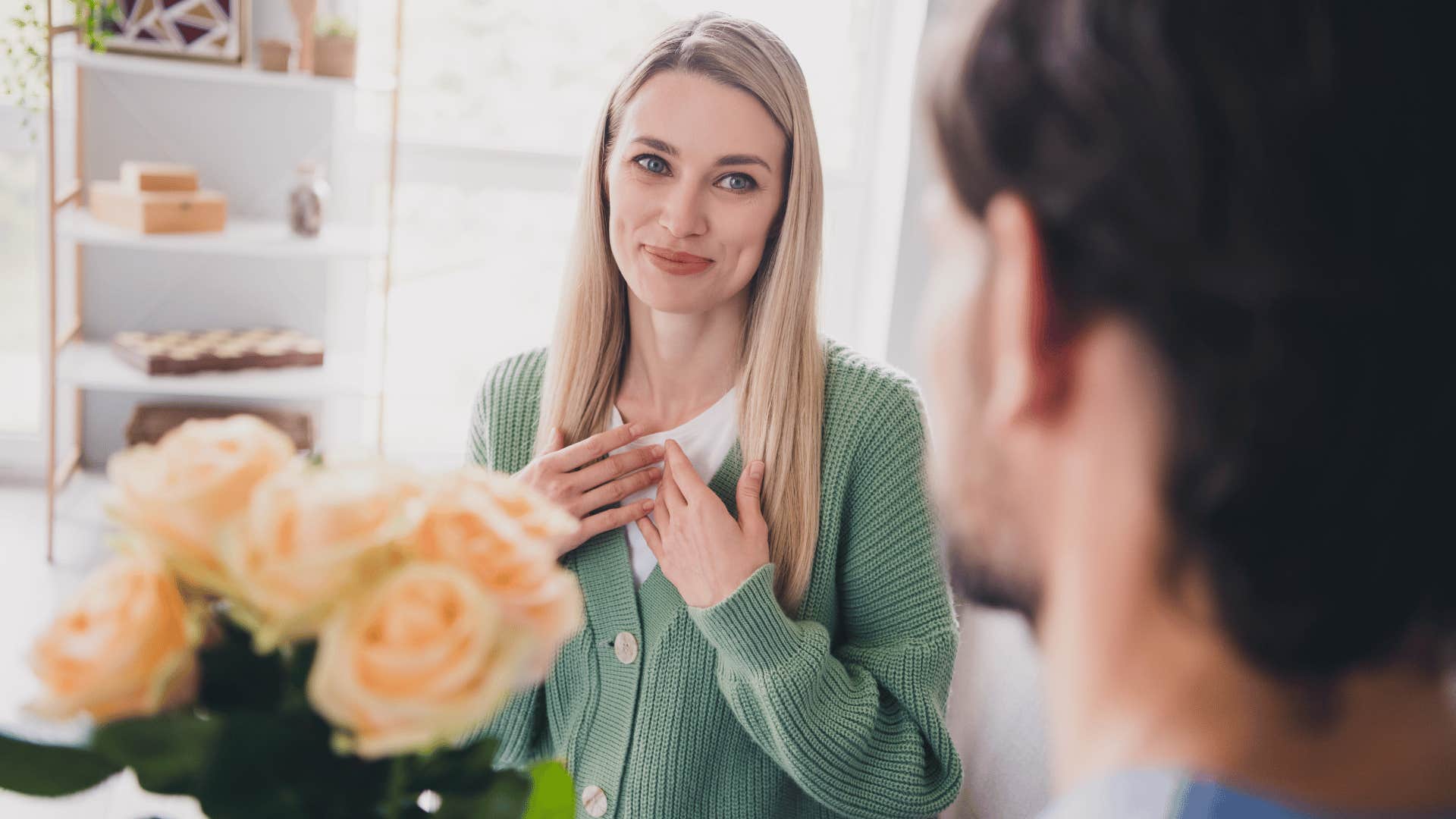 man putting in one-sided effort into the relationship as woman in green shirt excepts flowers