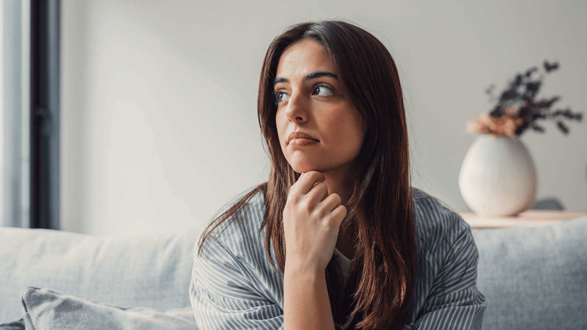 woman thinking about how she's scared to go all-in on relationships