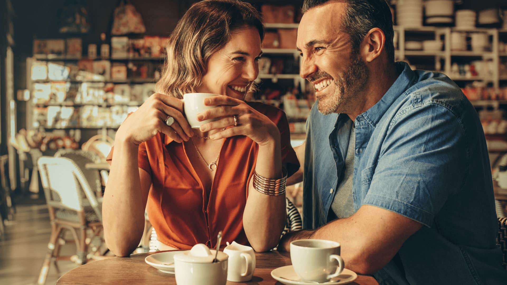 woman who is scared to go all-in on relationship drinking coffee with man