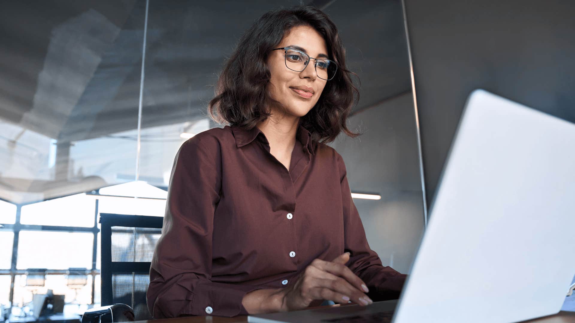serious dedicated woman working on her laptop