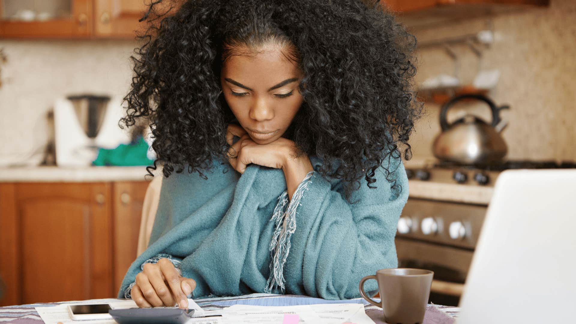 stressed woman doing bills at the table
