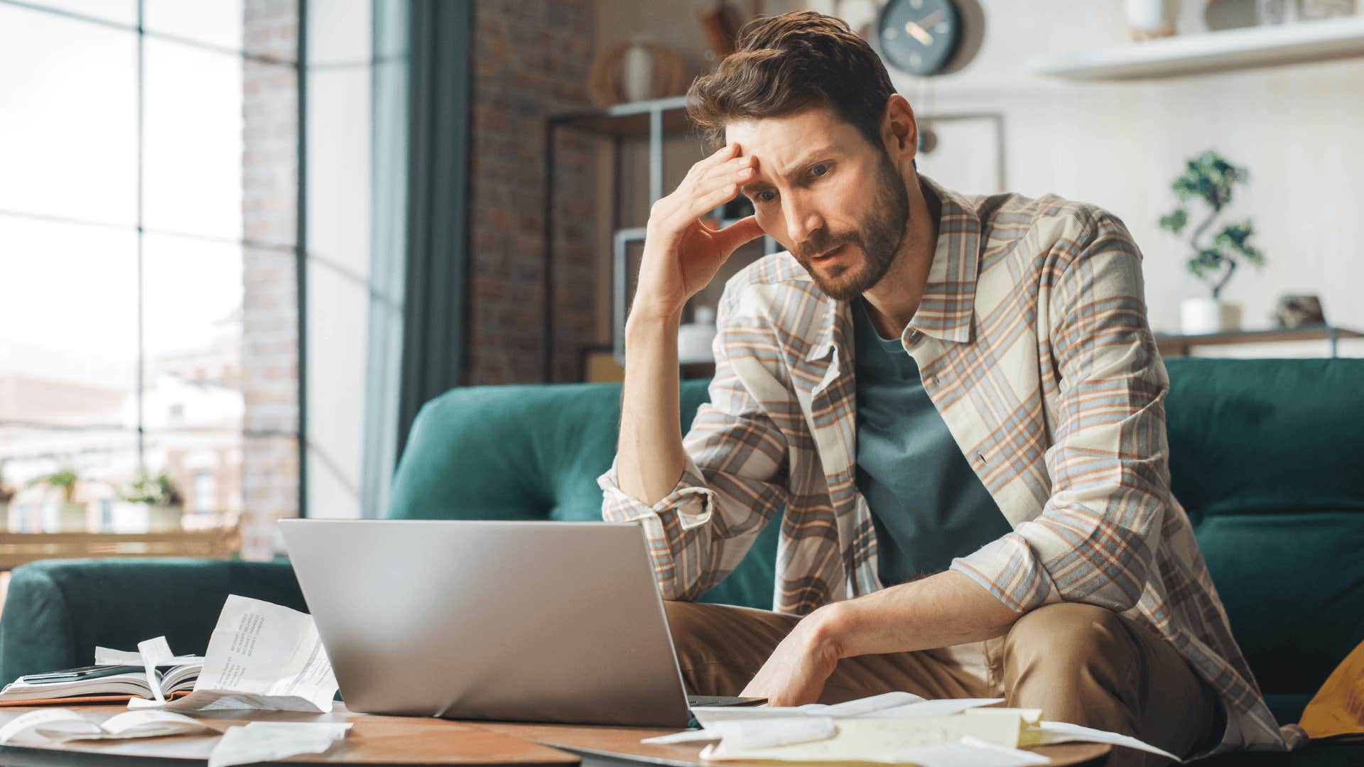 frustrated man paying bills