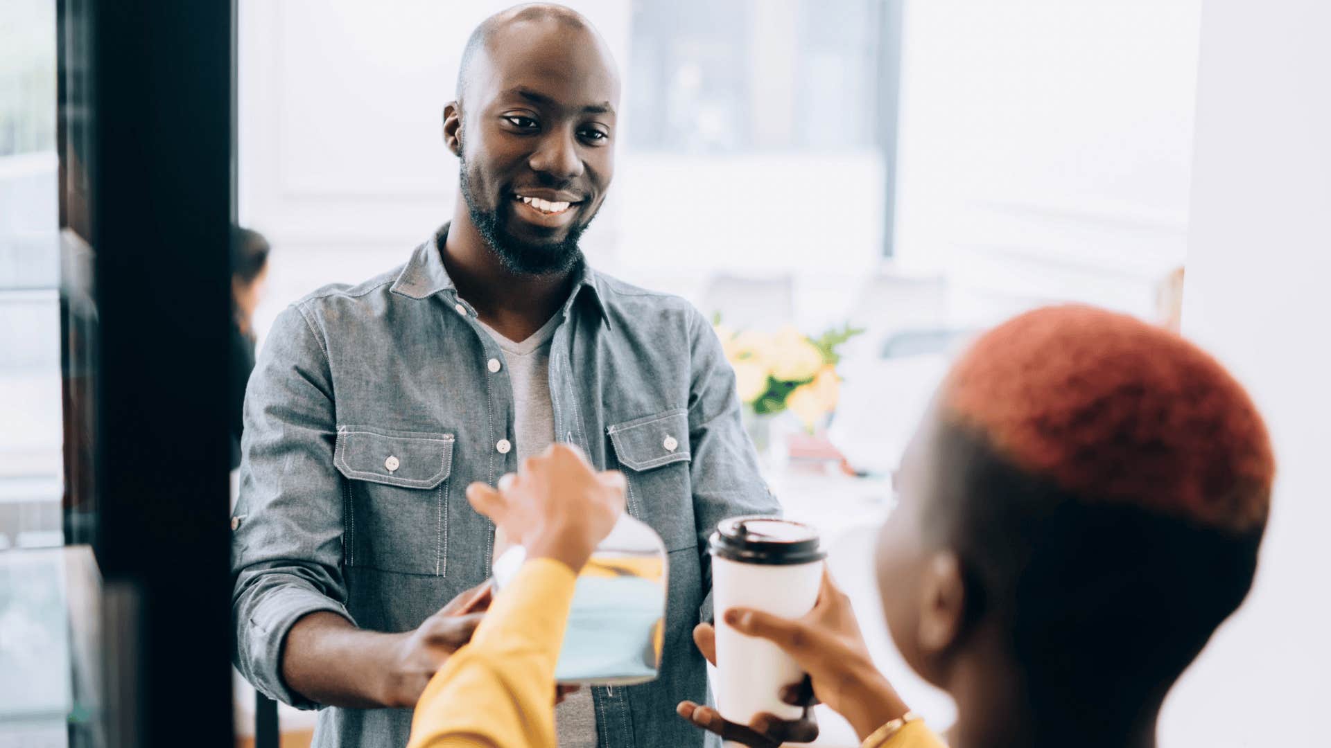 woman smiling and tipping barista
