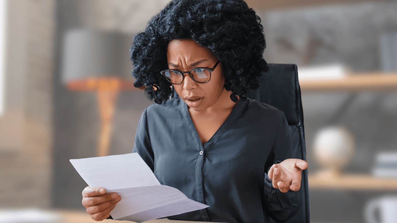 shocked stressed out woman going over her bills