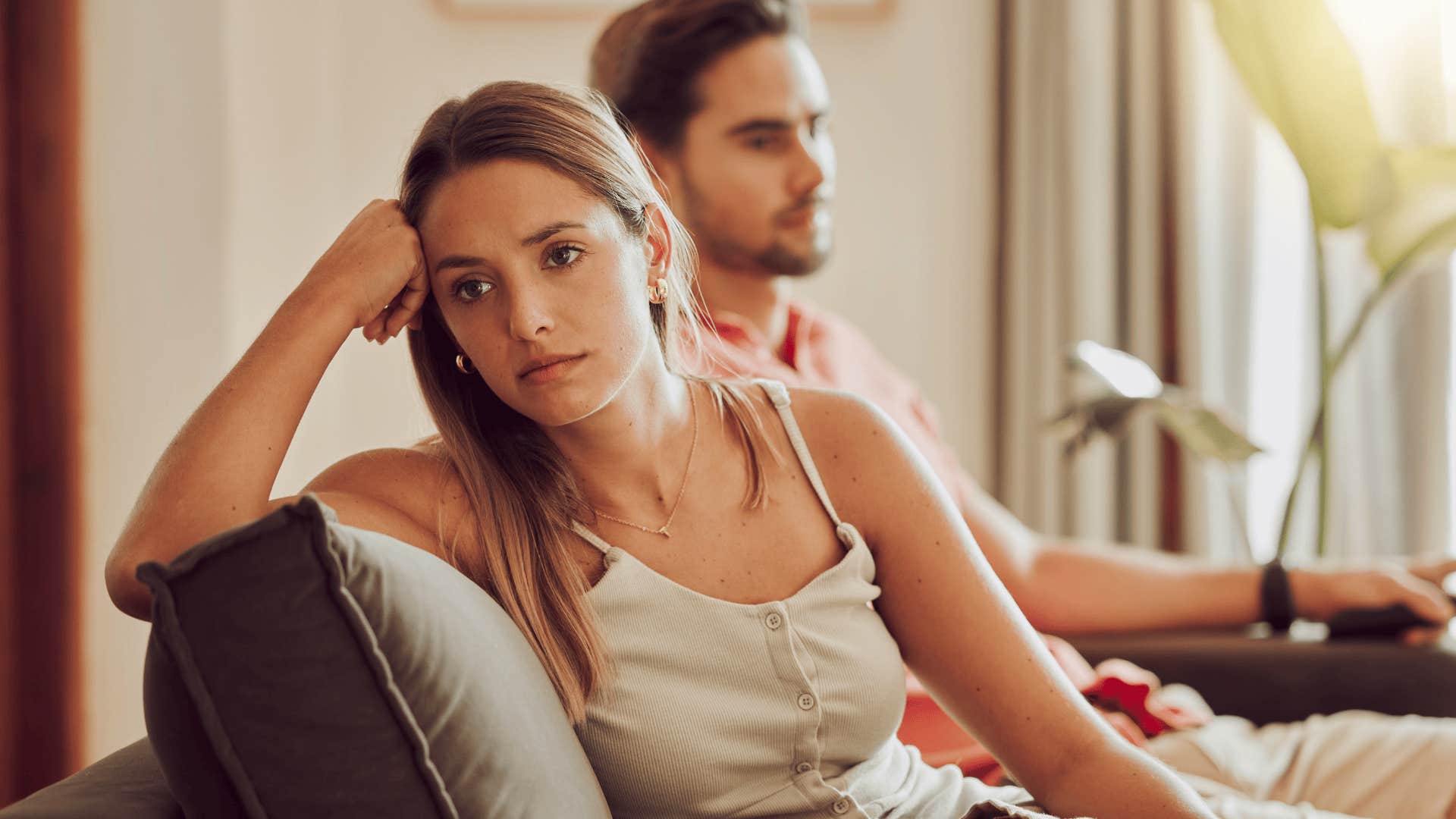 upset woman who is hard to love sitting next to man