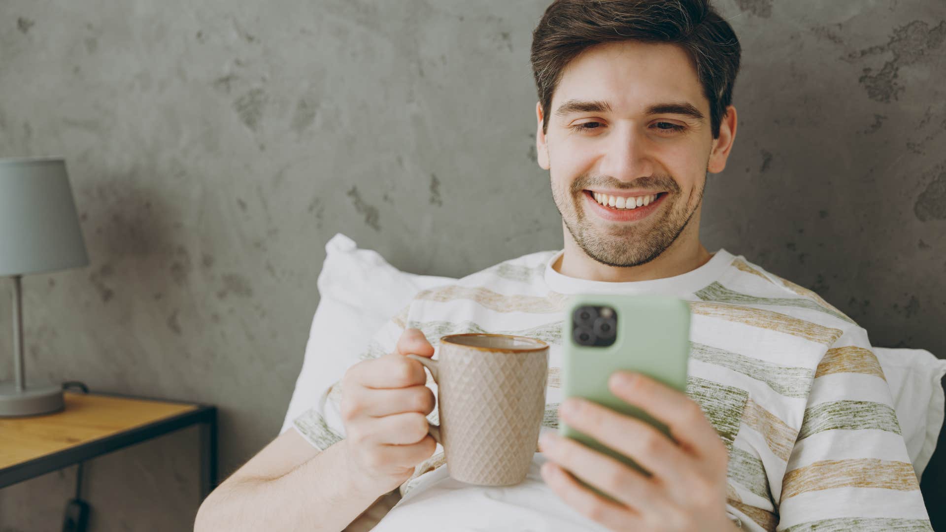 gen z man scrolling social media on his phone