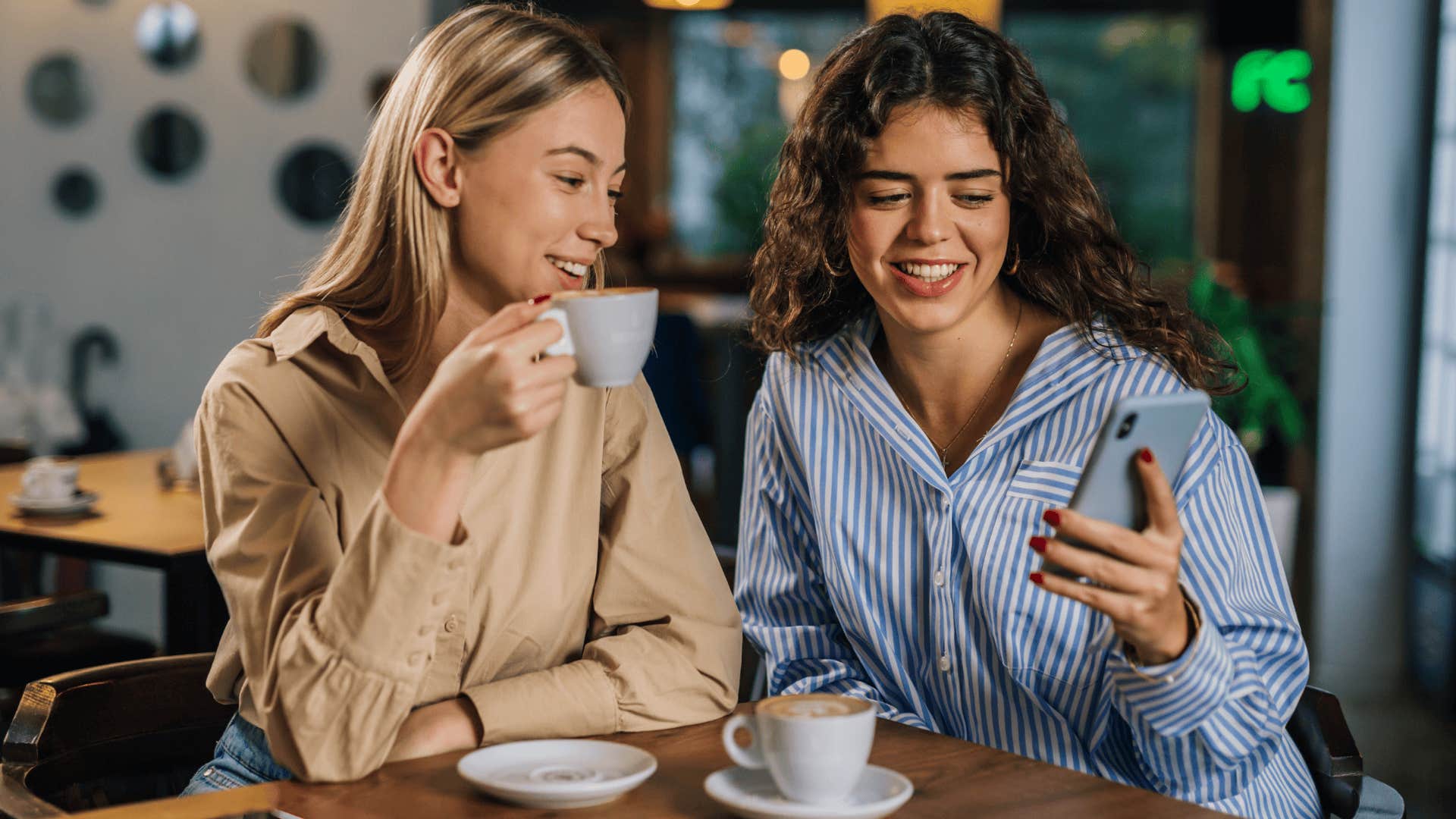 two young women chatting over coffee
