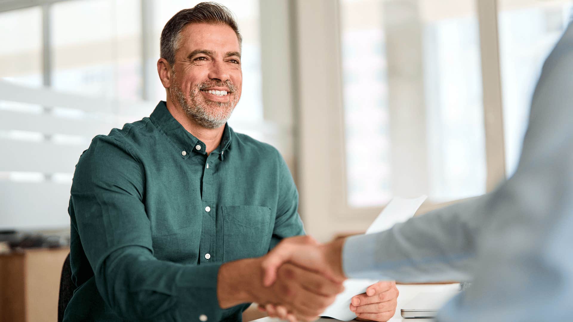 professional man shaking a peer's hand